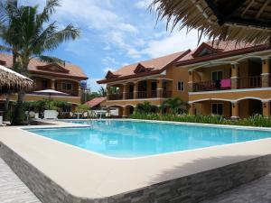 a swimming pool in front of a resort at SLAM'S Garden Dive Resort in Malapascua Island