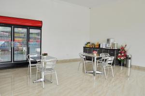 a restaurant with tables and chairs and a counter at Hotel Raub Agro in Raub