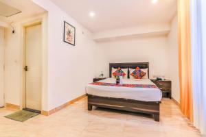 ein Schlafzimmer mit einem großen Bett in einem Zimmer in der Unterkunft FabHotel Oakwey Inn Indiranagar in Bangalore