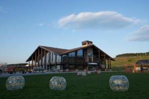 a building with domes in the grass in front of it at The View Changbai Mountain Mgallery in Fusong