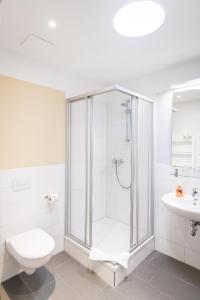 a bathroom with a shower and a toilet and a sink at Johanniterhaus Wittenberg in Lutherstadt Wittenberg