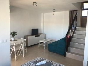 a living room with a staircase and a table at Aloha Playa - Front de mer in Benalmádena