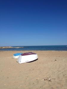 two boats are sitting on the sand on the beach at Apartament Orhidea in La Mata