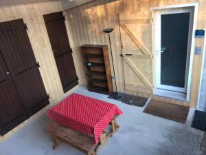 a room with a table with a red and white checkered table cloth at Les Terrasses de La Malcombe in Besançon