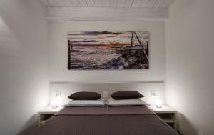 a bedroom with a bed and a painting on the wall at Best Vasto in Vasto +52 photos