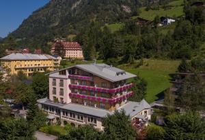 an aerial view of a building with pink flowers on it at Hotel Völserhof in Bad Hofgastein