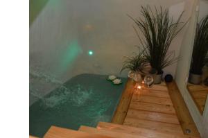 Una bañera de hidromasaje con una mesa y algunas plantas. en Ostuni 21mq Suite Homes, en Ostuni
