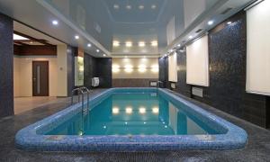 - une piscine au milieu d'une chambre avec un bâtiment dans l'établissement Admiral Hotel, à Saransk