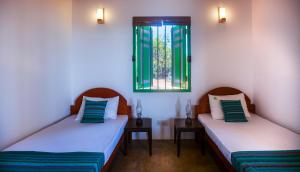 Krevet ili kreveti u jedinici u okviru objekta Nil Sisila Beach Resort Yala