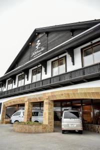 a white van parked in front of a building at Altitude Nozawa in Nozawa Onsen