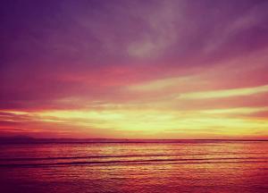 a sunset over a body of water at CHEZ ALEX in Nosy Be