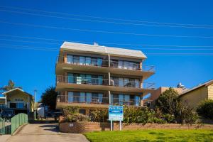 
a large building with a sign on the side of it at Pacific Pines Unit 6 in Narooma
