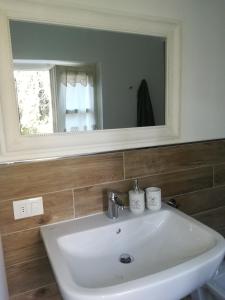a white sink in a bathroom with a mirror at DOLCE DORMIRE in Rovereto +71 photos