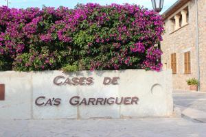 un mur avec des fleurs violettes au-dessus dans l'établissement Ca's Garriguer, à Valldemossa