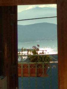 a view of the ocean from a window of a balcony at Sun View Guesthouse in Delphi