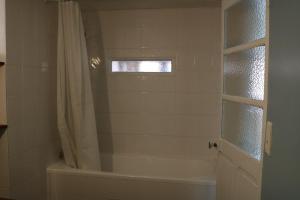 a bathroom with a tub and a shower with a window at Maison Cahors in Cahors +17 photos