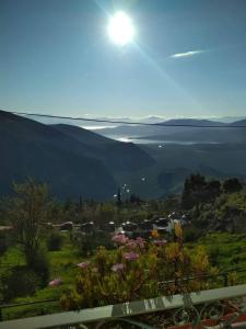 a view of a valley with the sun in the sky at Sun View Guesthouse in Delphi