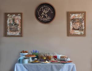 a table with a blue table cloth with food on it at Agriturismo Ai Linchi in Lucca