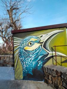 a painting of a blue fish on a wall at Massoni Bed and Breakfast in Peschiera del Garda