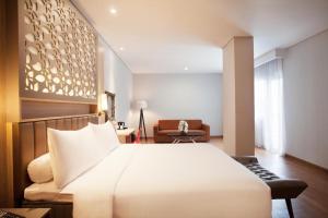 A bed or beds in a room at ibis Styles Cikarang