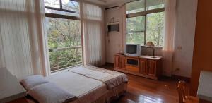 TV a/nebo společenská místnost v ubytování Ri Jing Yuan Homestay