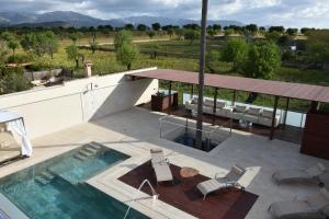 a house with a swimming pool and a table and chairs at Villa Rainbow Home Mallorca in Palma de Mallorca