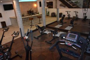 a gym with several exercise bikes and a treadmill at Villa Rainbow Home Mallorca in Palma de Mallorca