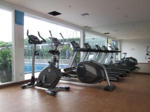 a gym with a row of treadms and elliptical machines at ibis Styles Cikarang in Cikarang