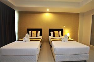 Postel nebo postele na pokoji v ubytování Retreat Resort Pattaya