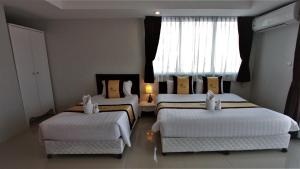 Postel nebo postele na pokoji v ubytování Retreat Resort Pattaya