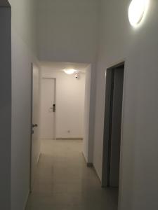 an empty hallway with a white door and a hallwayngth at CH-Hostel in Vienna