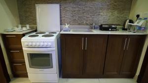 a kitchen with a white stove and a sink at DIAMOND SUITES in Al Khobar