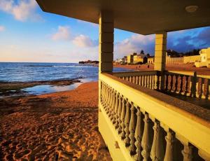 a view of the beach from the balcony of a house at La stella di Montalbano con parcheggio privato in Punta Secca