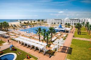 an aerial view of a resort with a pool and a beach at Concorde Marco Polo in Hammamet