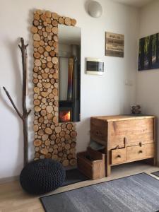 a room with a fireplace and a wooden dresser at Hillside Bio Resort Delux Apartments in Šešče pri Preboldu