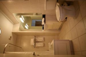 a bathroom with a sink and a toilet and a mirror at Hotel Newport in Newport
