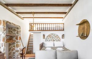 a living room with a ladder and a couch at Limeri Traditional Guest House in Monólithos