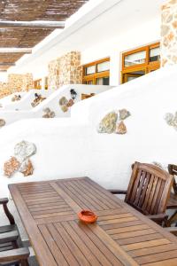 a wooden table and a chair on a patio at Limeri Traditional Guest House in Monólithos