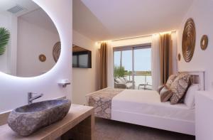 a bathroom with a sink and a bed and a mirror at Villa Rainbow Home Mallorca in Palma de Mallorca +23 photos