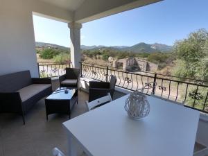 a balcony with a table and chairs and a view at Villino Blu Mare in San Teodoro