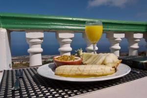 a plate of food on a table with a glass of orange juice at Hotel Ida Inés in Frontera