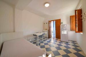 a small kitchen with a table and a refrigerator at Residence Dattoli in Peschici