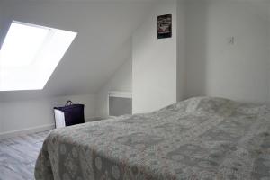 a white room with a bed and a window at Maisonnette 4 pers- Piscine commune - Plage à 500 m- AESA in Guidel-Plage