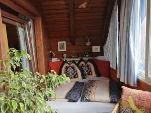 a bedroom with a bed with pillows on it at Apartments Krista in Seeboden