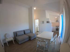 a living room with a couch and a table at Villino Blu Mare in San Teodoro