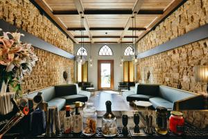 a living room with couches and a table with flowers at El Boutique Hotel in Soûr