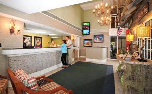 a woman standing at the counter of a restaurant at Holiday Pavilion Resort on the Boardwalk in Myrtle Beach +29 photos