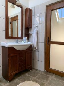 a bathroom with a sink and a mirror at Rozsi Mama in Sovata +89 photos