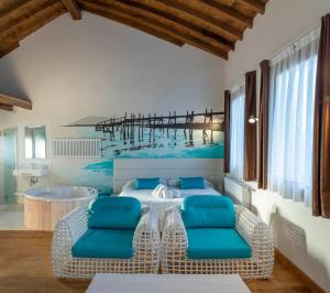 a room with a table and chairs and a pier at Somo Garden Villas in Somo