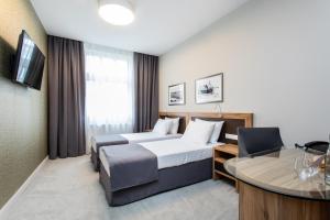 Televízia a/alebo spoločenská miestnosť v ubytovaní Jakubowy Hotel